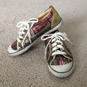 Coach tennis shoes cream with gold trim.